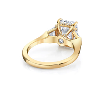 Three stone emerald cut diamond engagement ring