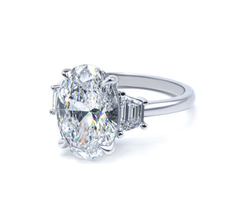 Three stone oval cut diamond engagement ring