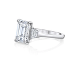 Three stone emerald cut diamond engagement ring