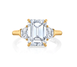 Three stone emerald cut diamond engagement ring