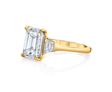 Three stone emerald cut diamond engagement ring