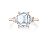 Three stone emerald cut diamond engagement ring