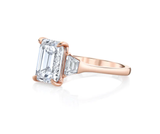 Three stone emerald cut diamond engagement ring