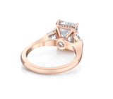 Three stone emerald cut diamond engagement ring