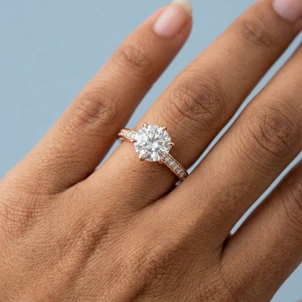 Hand model shot of the rose gold engagement ring