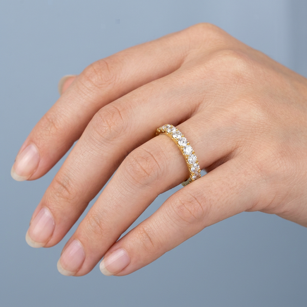 Hand model shot of the yellow gold Single French Cut Pave diamond wedding band
