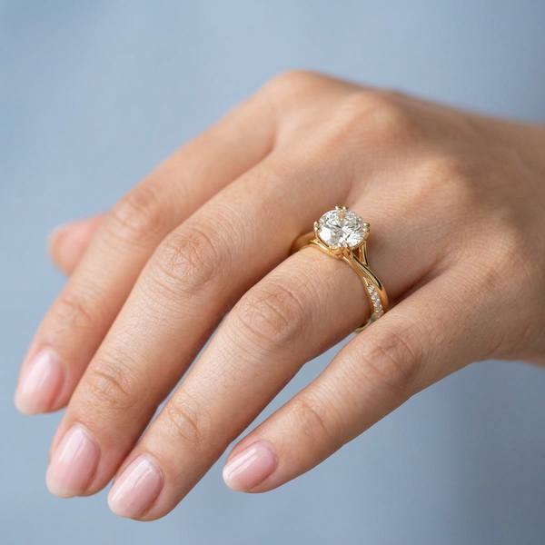 Hand model shot of the yellow gold engagement ring