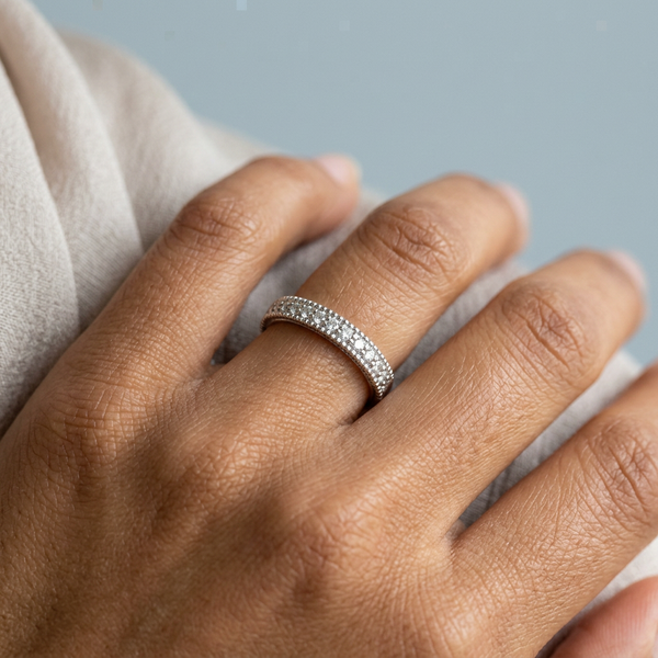 Hand model shot of the white gold Single French Cut Pave diamond wedding band
