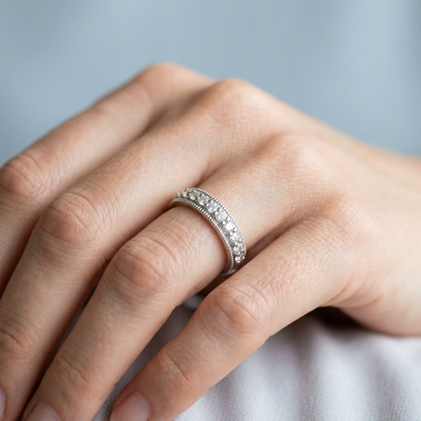 Hand model shot of the white gold Single French Cut Pave diamond wedding band