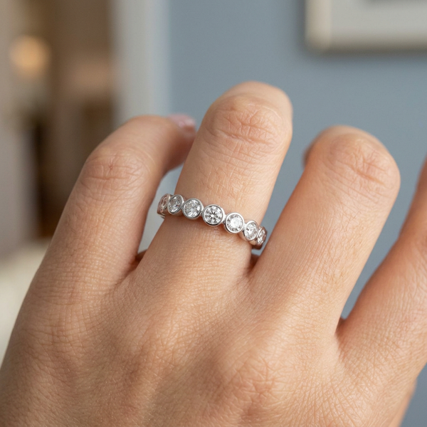 Hand model shot of the white gold Single French Cut Pave diamond wedding band