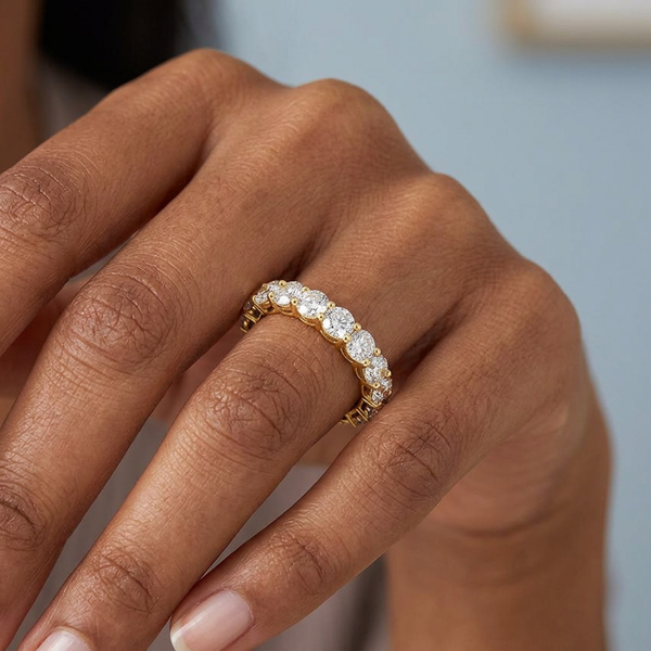 Hand model shot of the yellow gold Single French Cut Pave diamond wedding band