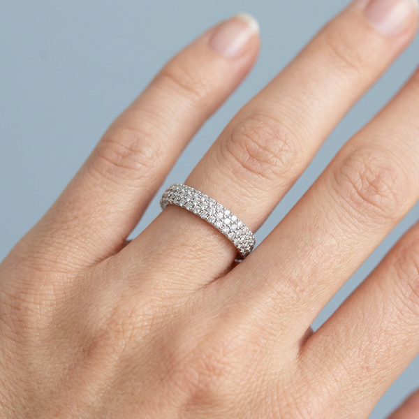 Hand model shot of the white gold Single French Cut Pave diamond wedding band