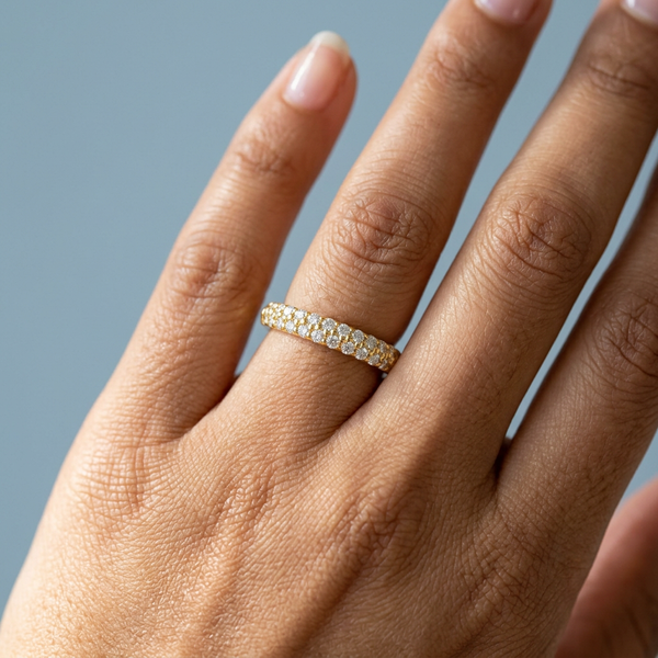 Hand model shot of the yellow gold diamond wedding band