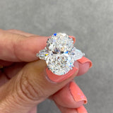 Three stone oval cut diamond engagement ring