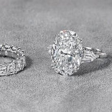 Three stone oval cut diamond engagement ring