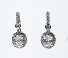 1.30 + carat Oval Cut Lab Grown Diamond Earrings, set in the halo.