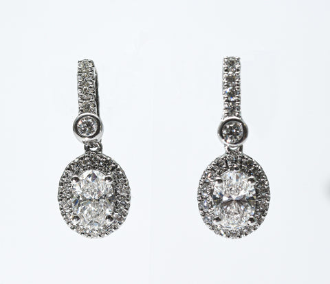 1.30 + carat Oval Cut Lab Grown Diamond Earrings, set in the halo.